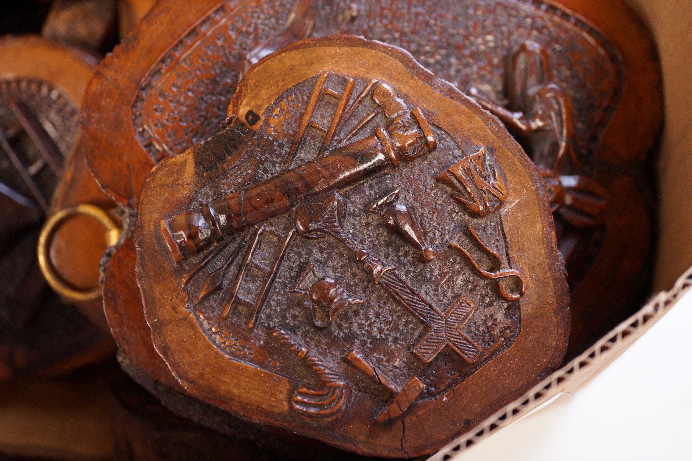 A collection of Jerusalem carved oyster olive wood roundels, religious and other symbolism